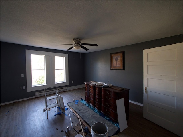 interior space with a baseboard heating unit, hardwood / wood-style floors, a textured ceiling, and ceiling fan