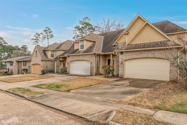 view of front of home with brick siding, driveway, an attached garage, and roof with shingles