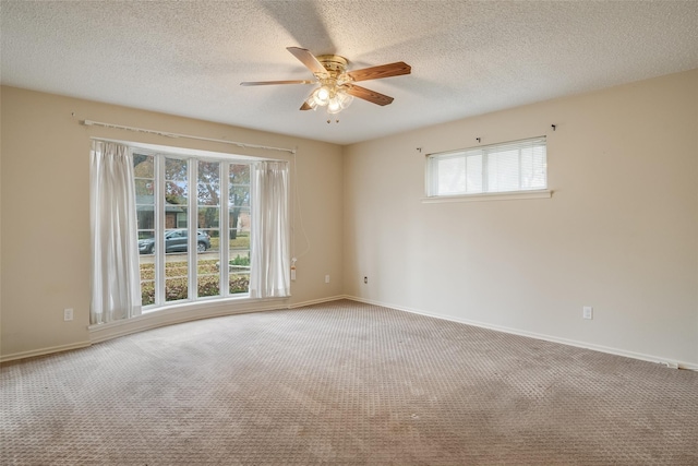 carpeted empty room featuring ceiling fan and a textured ceiling