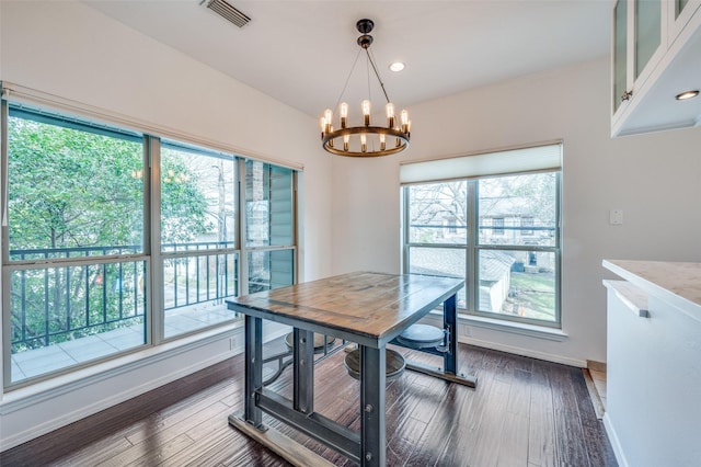 dining room featuring an inviting chandelier and dark wood-type flooring