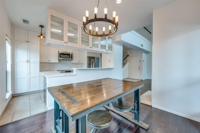 dining room with an inviting chandelier and dark hardwood / wood-style flooring