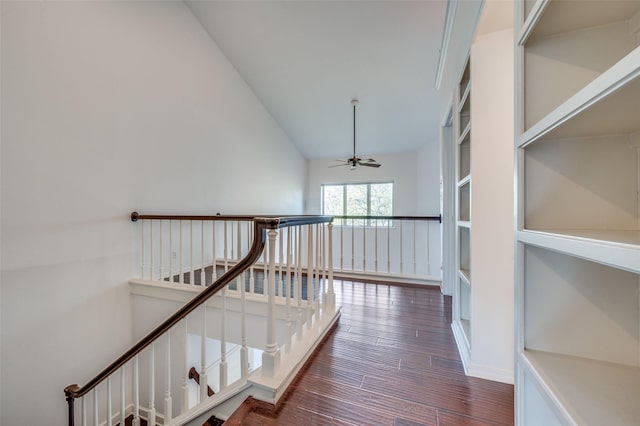 hallway featuring lofted ceiling and dark hardwood / wood-style flooring