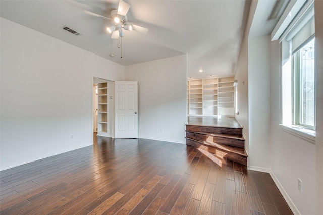 interior space with ceiling fan and dark hardwood / wood-style floors