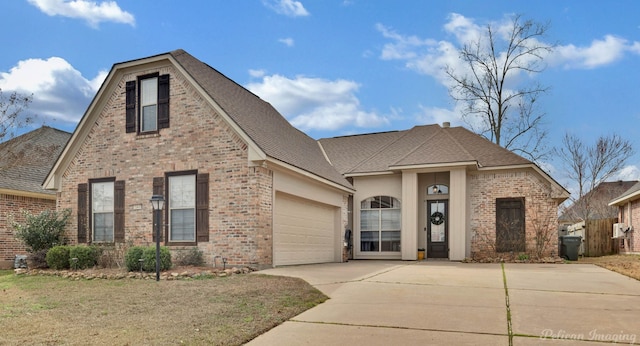 front facade featuring a garage and a front yard