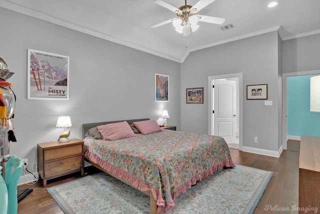 bedroom with lofted ceiling, crown molding, ceiling fan, and hardwood / wood-style flooring