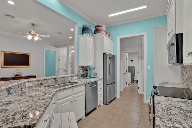 kitchen featuring white cabinetry, sink, ornamental molding, and stainless steel appliances