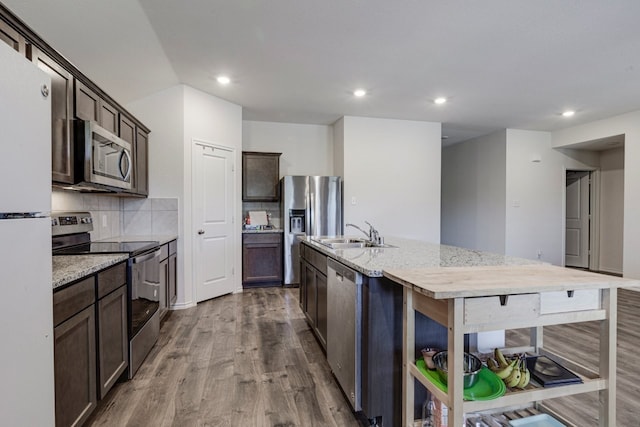 kitchen featuring dark wood-style floors, dark brown cabinets, stainless steel appliances, and a sink