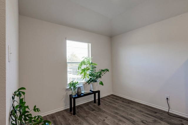 interior space with baseboards and dark wood-style floors