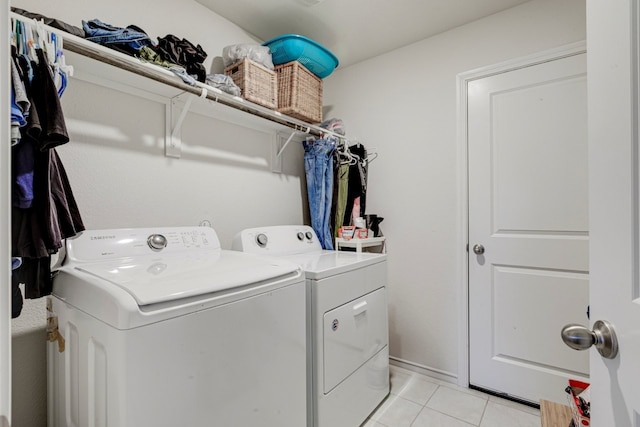 laundry room featuring washer and clothes dryer, laundry area, and light tile patterned floors