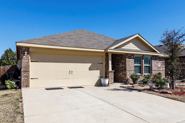 single story home with brick siding, concrete driveway, an attached garage, and a shingled roof