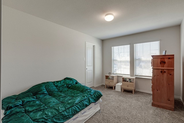 carpeted bedroom with baseboards