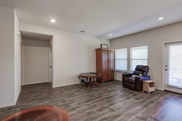 sitting room featuring visible vents, baseboards, and wood finished floors