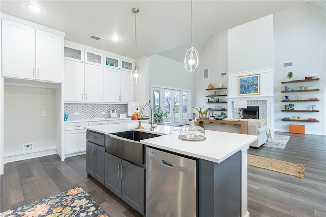 kitchen featuring gray cabinetry, a center island with sink, stainless steel dishwasher, pendant lighting, and white cabinets