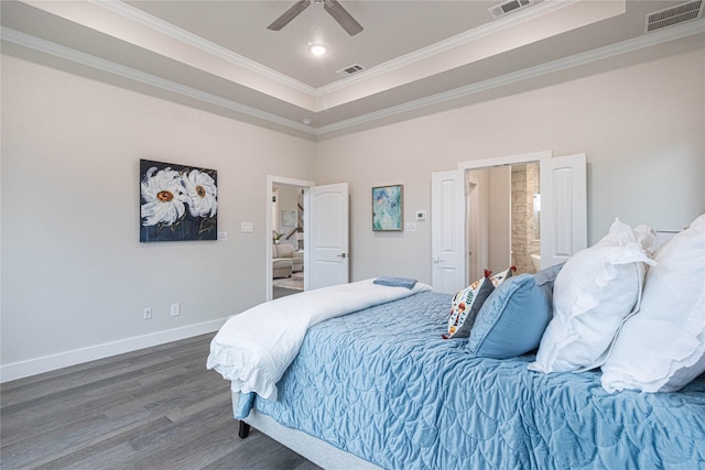 bedroom with dark hardwood / wood-style flooring, crown molding, a tray ceiling, and ceiling fan