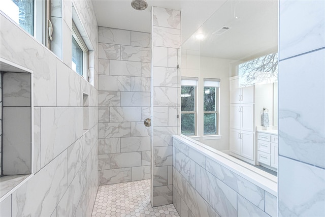 bathroom with tiled shower