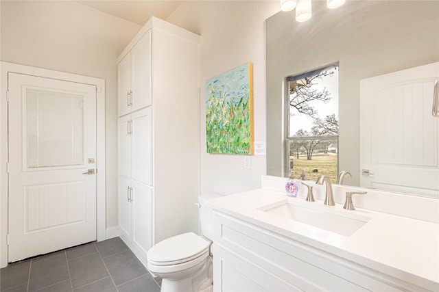 bathroom featuring tile patterned floors, toilet, and vanity