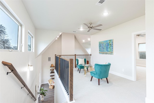 sitting room featuring ceiling fan and carpet flooring