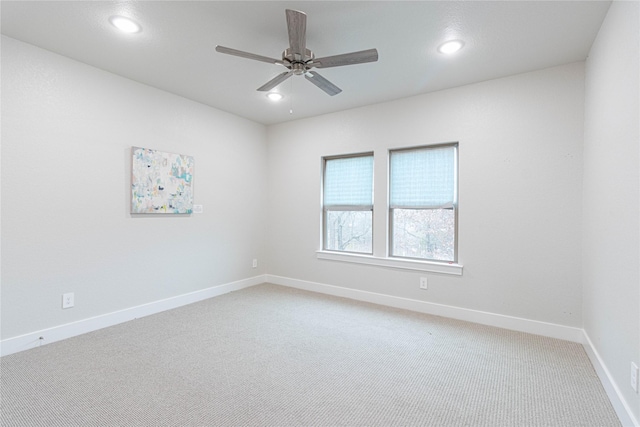 empty room with ceiling fan and carpet