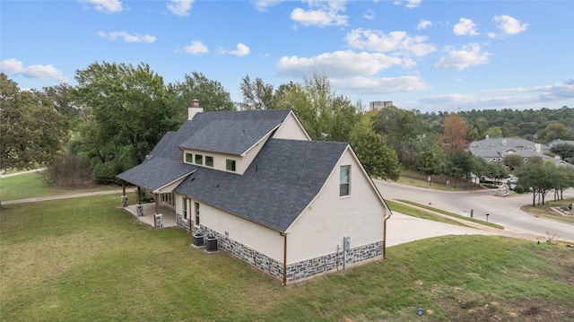 view of home's exterior with central AC and a lawn