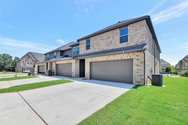 view of front of property with a garage, central air condition unit, and a front lawn