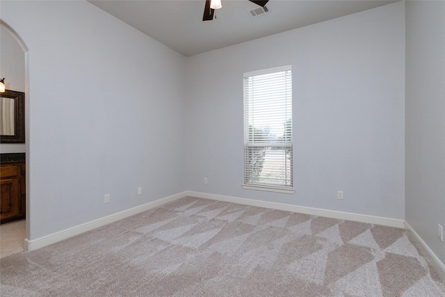 carpeted spare room with ceiling fan