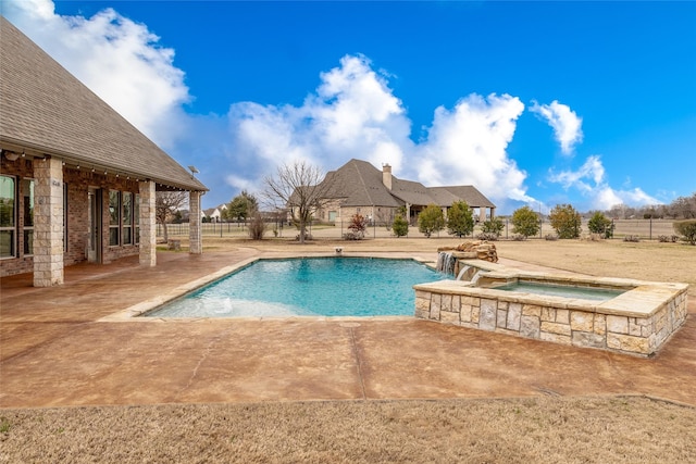 view of pool with a patio and an in ground hot tub