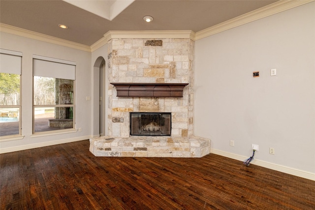 unfurnished living room with ornamental molding, dark hardwood / wood-style floors, and a fireplace