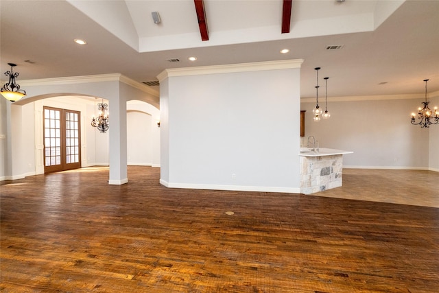 unfurnished living room with french doors, crown molding, a chandelier, dark hardwood / wood-style flooring, and beamed ceiling