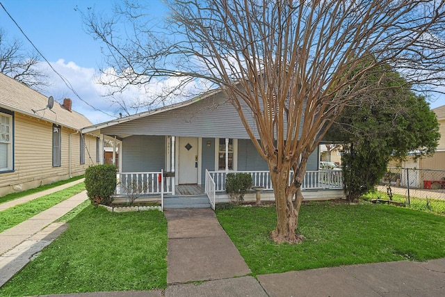 bungalow-style house with a front lawn and covered porch