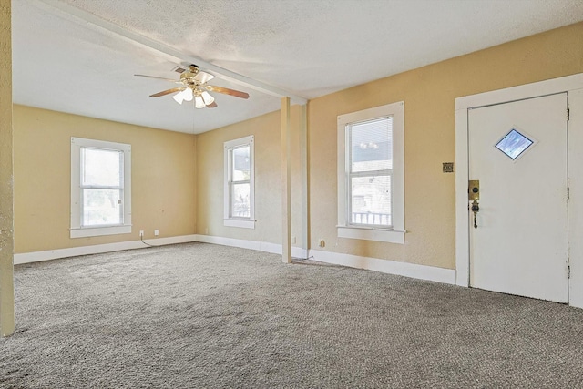 interior space featuring ceiling fan and a textured ceiling