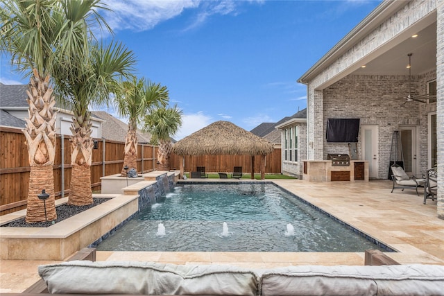 view of swimming pool with area for grilling, a gazebo, exterior kitchen, a fenced in pool, and a patio area