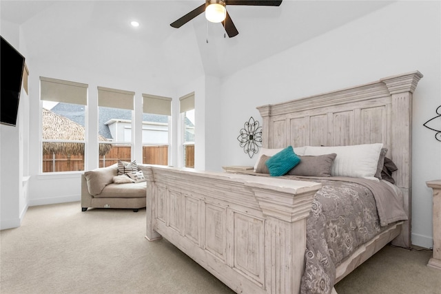 bedroom with high vaulted ceiling, light colored carpet, and ceiling fan