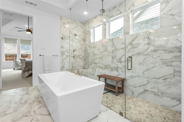 bathroom featuring ceiling fan, plus walk in shower, and a wealth of natural light