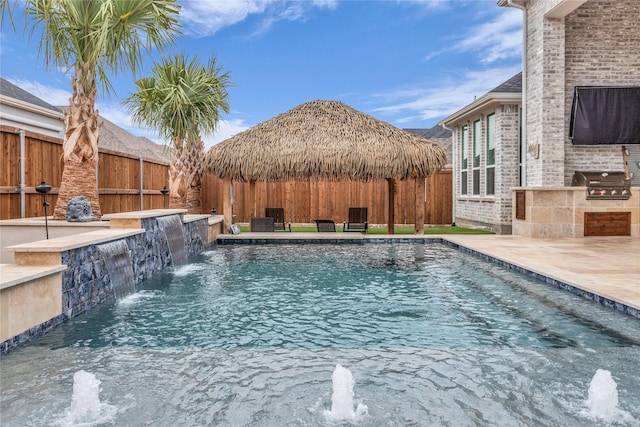 view of pool with pool water feature, area for grilling, a gazebo, and a patio area