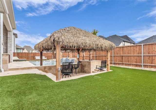 view of yard featuring pool water feature, an outdoor bar, a fenced in pool, and a patio area