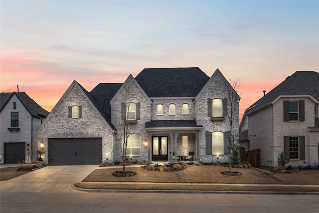 french country home with a garage