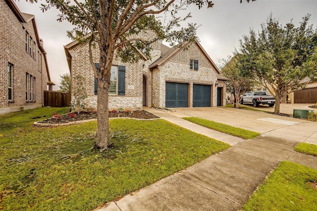 view of front of home with a garage and a front lawn