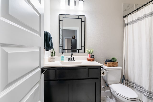 bathroom featuring vanity, a shower with shower curtain, and toilet