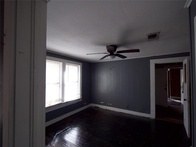 unfurnished room featuring ceiling fan, dark hardwood / wood-style flooring, and a textured ceiling