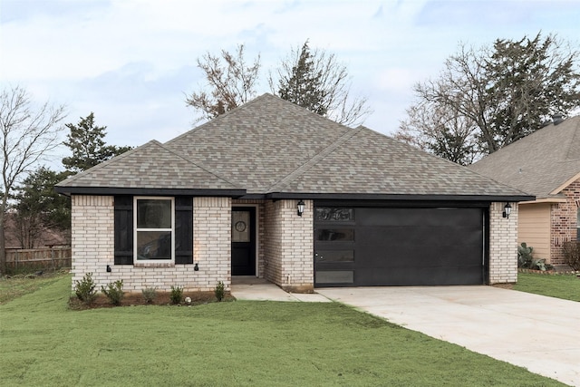 view of front of property featuring a garage and a front yard