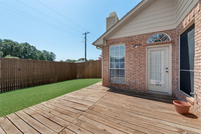 wooden deck with a lawn