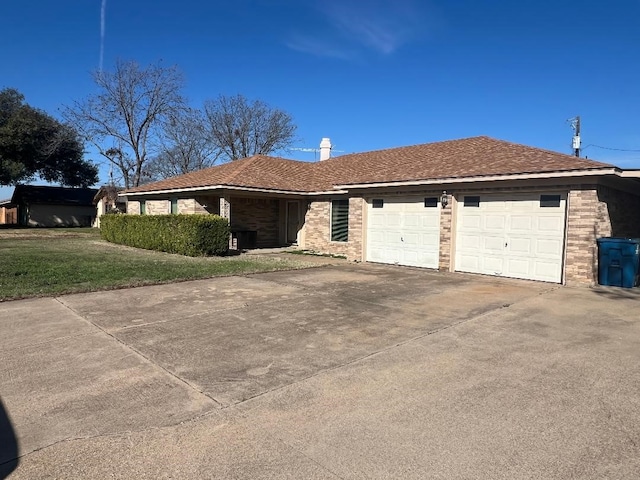 single story home with a garage and a front lawn