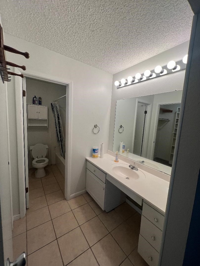 full bathroom with shower / tub combo with curtain, toilet, a textured ceiling, vanity, and tile patterned flooring