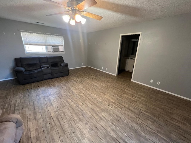 living room featuring hardwood / wood-style floors, a textured ceiling, and ceiling fan