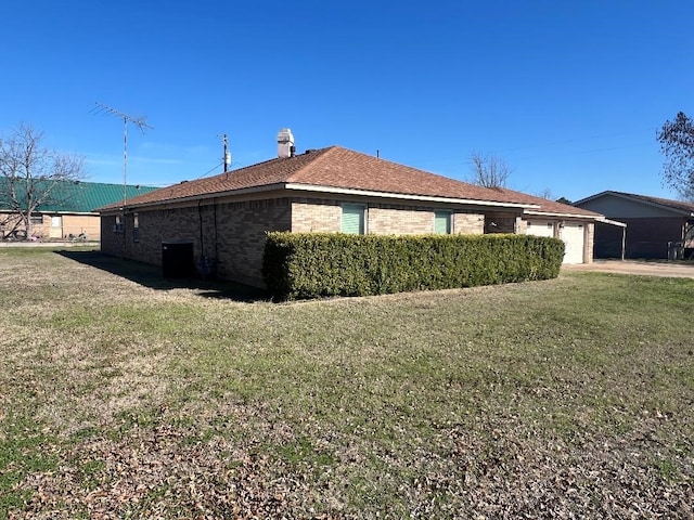 view of side of home with a yard