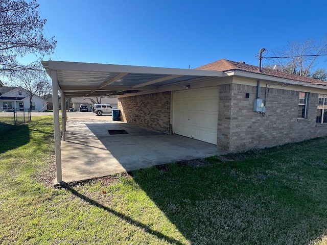 exterior space featuring a carport, a garage, and a lawn