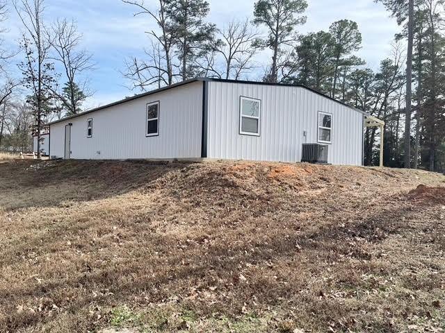 view of outdoor structure featuring central air condition unit