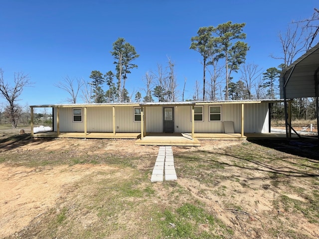 rear view of house with a wooden deck