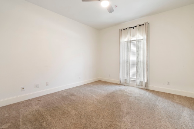 empty room featuring carpet floors and ceiling fan