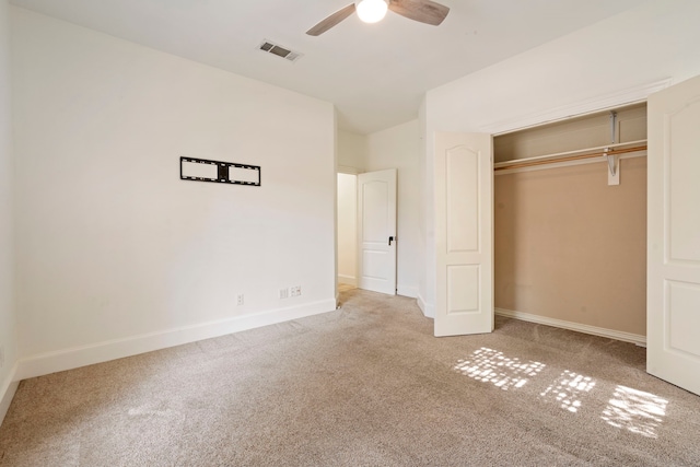 unfurnished bedroom featuring carpet flooring, ceiling fan, and a closet